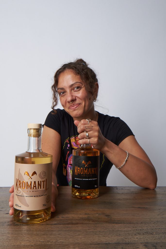 Dani with her plaintain-infused rum as well as her brand's original product. This is the backbone of their brand.